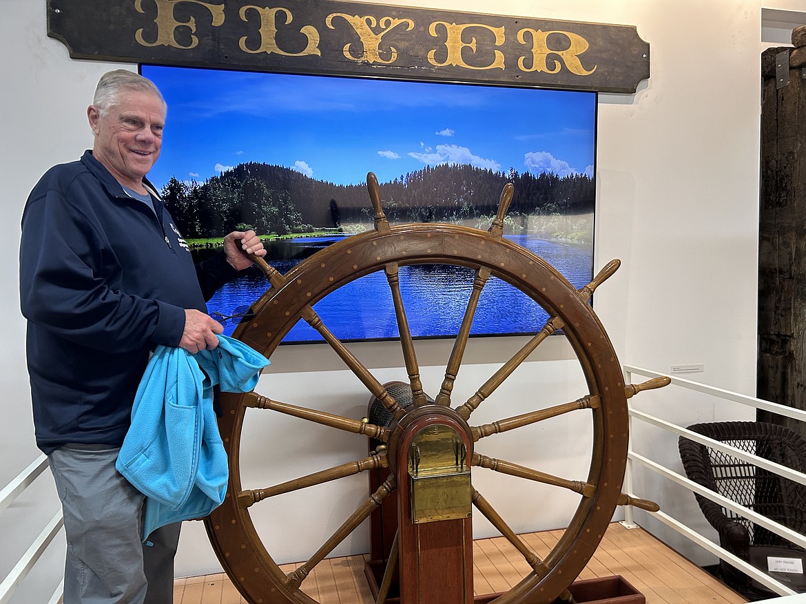Pancho Edler takes the helm of the "Flyer" during the grand opening of the Museum of North Idaho on Friday.