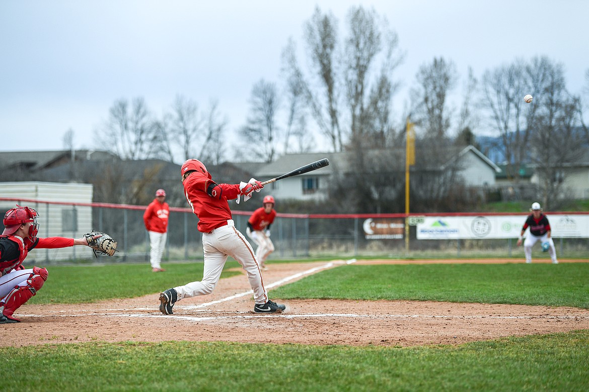 Lakers AA's Hunter Fann (15) drives in two runs with an RBI double in the second inning against the Calgary Cardinals at Griffin Field on Saturday, April 19. (Casey Kreider/Daily Inter Lake)