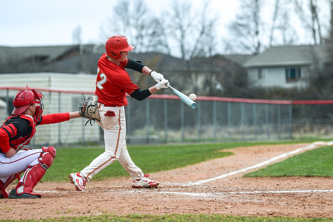 Lakers AA's Luke Nikunen (12) drives in a run with an RBI double in the second inning against the Calgary Cardinals at Griffin Field on Saturday, April 19. (Casey Kreider/Daily Inter Lake)