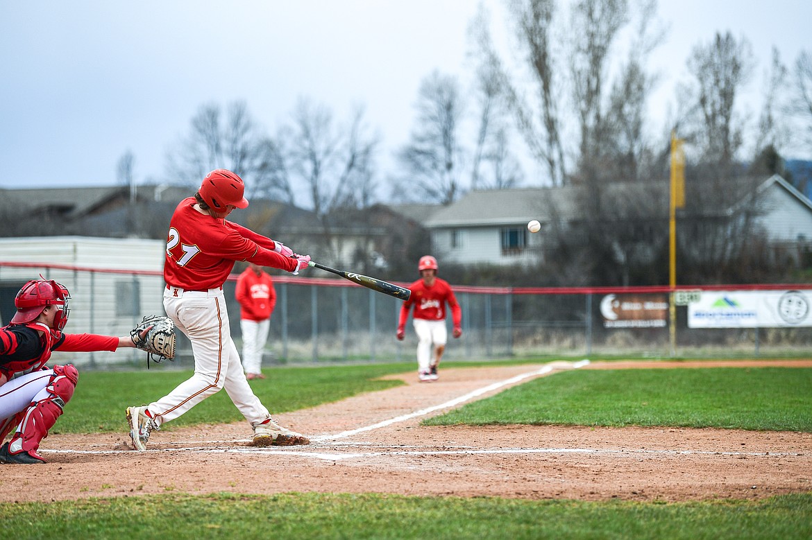 Lakers AA's Kaeden Kahler (21) connects on an RBI triple in the first inning against the Calgary Cardinals at Griffin Field on Saturday, April 19. (Casey Kreider/Daily Inter Lake)