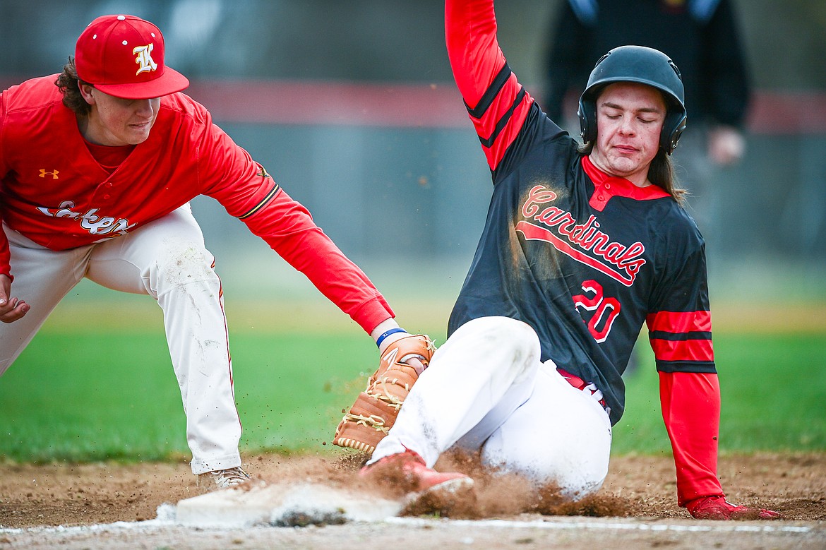 Lakers AA first baseman Kaeden Kahler (3) applies a tag from a snap throw down to first on Calgary Cardinals baserunner Evan Drake (20) at Griffin Field on Saturday, April 19. (Casey Kreider/Daily Inter Lake)