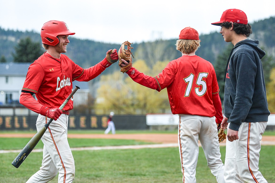 Lakers AA's Oscar Kallis (3) is congratulated after scoring on an RBI triple by Kaeden Kahler in the first inning against the Calgary Cardinals at Griffin Field on Saturday, April 19. (Casey Kreider/Daily Inter Lake)