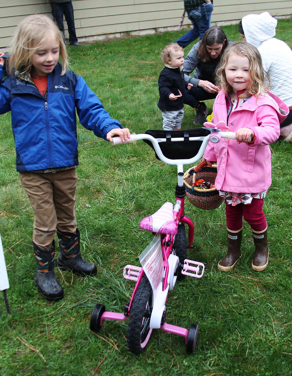 Tucker stands with the bike he selected for his sister, Vivian, after he found a special ticket during the Sandpoint Lions's annual Easter egg hunt on Saturday.