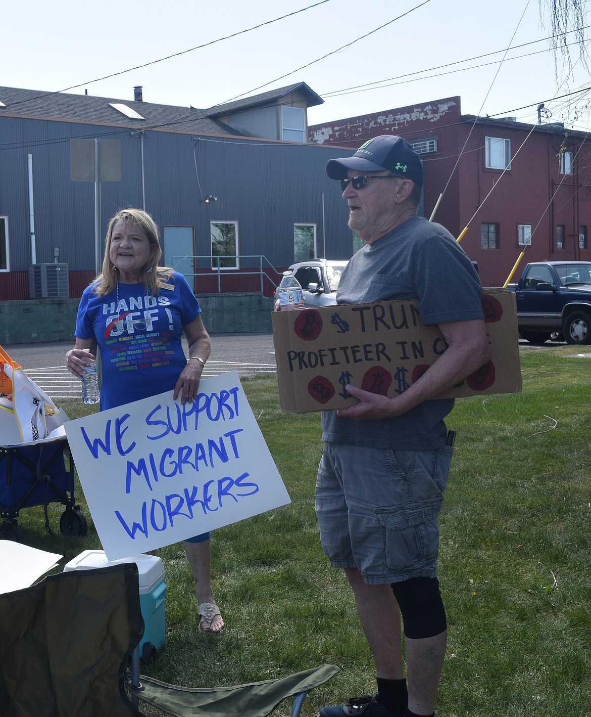 Grant County Democrats Vice Chair Jill Springer Forrest and protestor Dan Inman talk at the end of the protest Saturday. A group of around 120 people gathered by Walgreens from 11 a.m. to 1 p.m. to protest President Donald Trump and his administration.