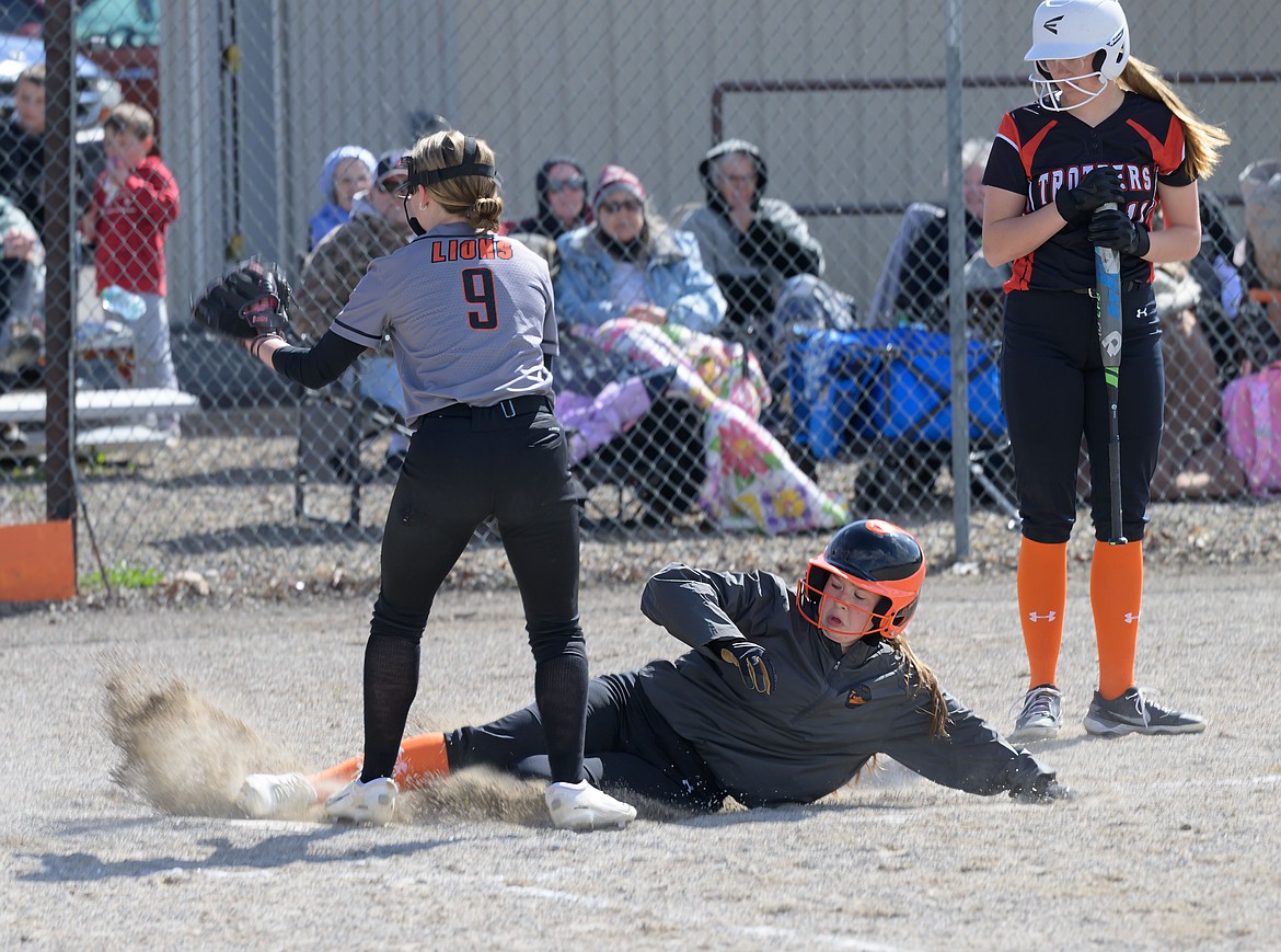 Plains' Cooper Spurr slides safely across home plate during the Trotters 18-16 win over Eureka this past Thursday in Plains. (Tracy Scott, Valley Press)