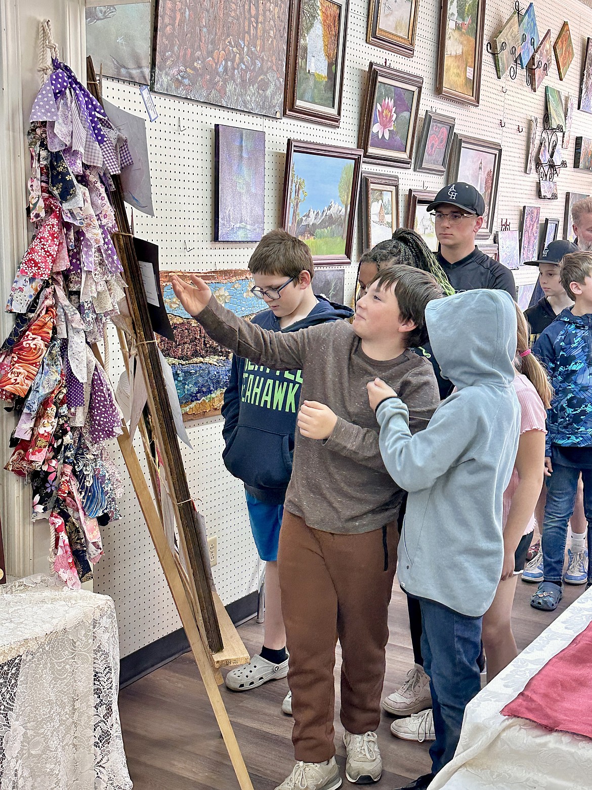From left: Austin King, Max Beal, Kalaya Garza (behind Max), Andrew Berkey, William Allsbrook and Ben Grindy check out what prizes their artwork has won at the Highlighters Art Club Gallery April 15. This is the 24th year the club has hosted the contest.