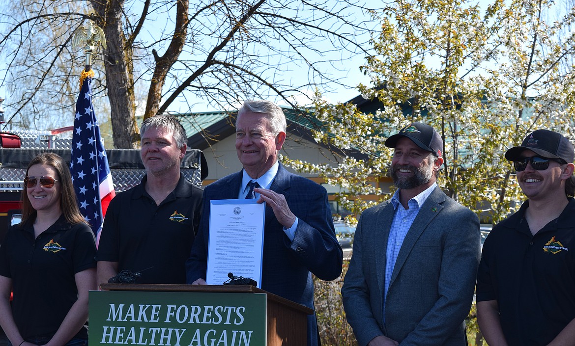 Governor Brad Little (center) stands with Idaho Department of Lands representatives, including IDL Director Dustin Miller (right of center) after signing the "Make Forests Healthy Again Act" in Coeur d'Alene on Tuesday.