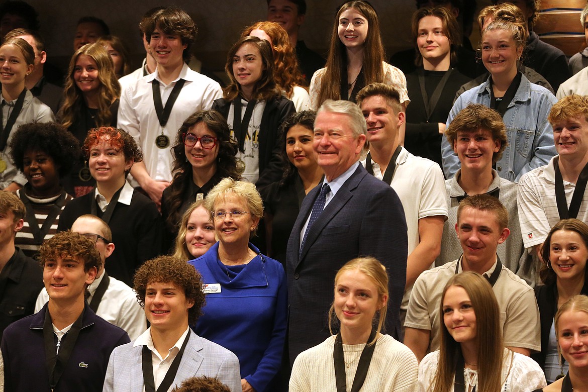 Idaho State Board of Education board member Shawn Keough, center left, and Idaho Gov. Brad Little stand among scholarship recipients Tuesday morning at the Coeur d'Alene Resort.