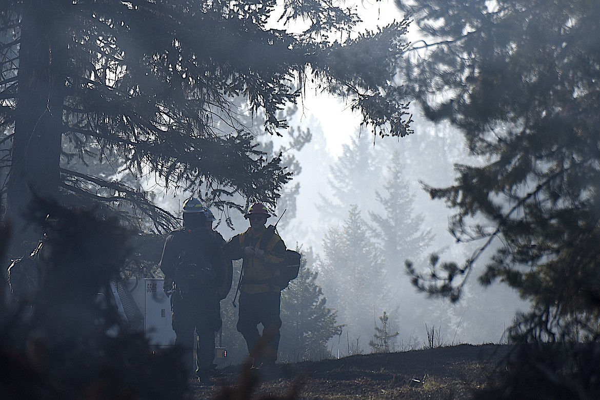 Montana Department of Natural Resources and Conservation fire crews monitor the West Camp Fire near Happy's Inn on the morning of Thursday, April 24, 2025. (Scott Shindledecker/The Western News)