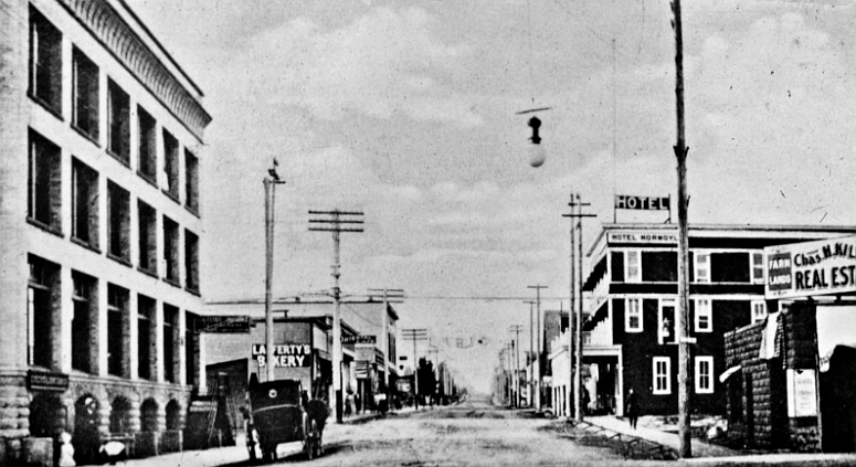 This Cardinell-Vincent postcard from the Museum of North Idaho collection shows what may well be Coeur d’Alene’s first cement sidewalk as it looked on the west side of Second Street from Sherman Avenue to the alley. The east side of the street appears to still have a wooden sidewalk running between the Charles Kildea Real Estate building and the Hotel Normoyle. The old Coeur d’Alene Bank building, which is adjacent to the cement walk, was recently demolished to make way for the new Coeur d’Alene Resort Tower.