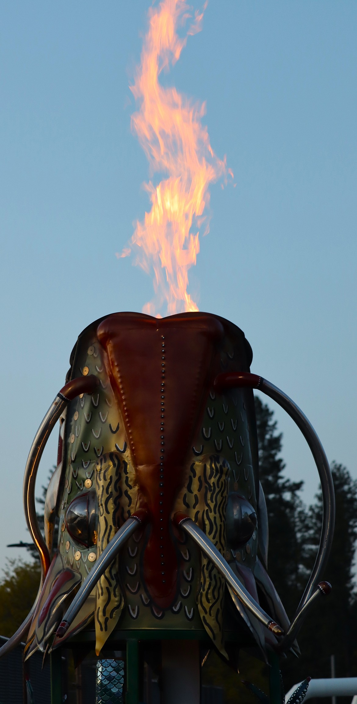 "Sid" The Green Energy Dragon breathes flames outside the wastewater treatment plant Thursday evening.