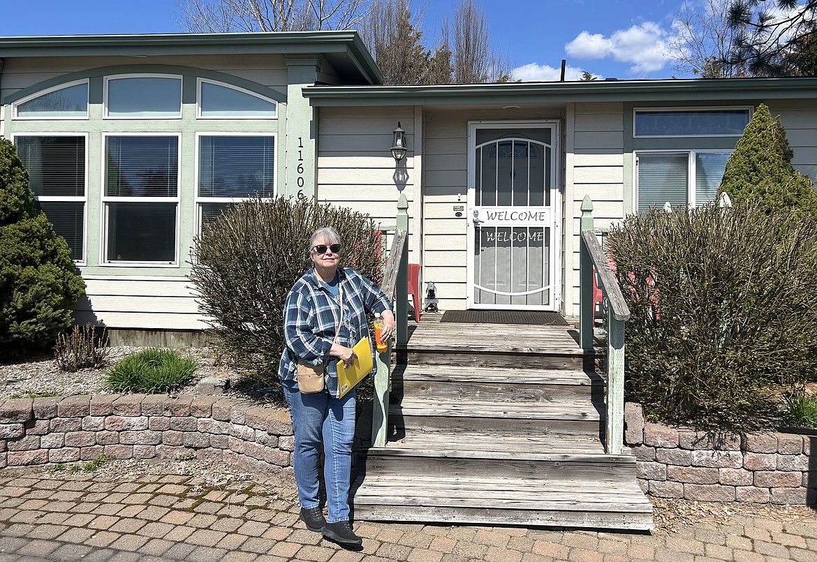 Johnnie Landis stands in front of her triplewide mobile home, which is for sale at Sun Aire Estates in Hayden.