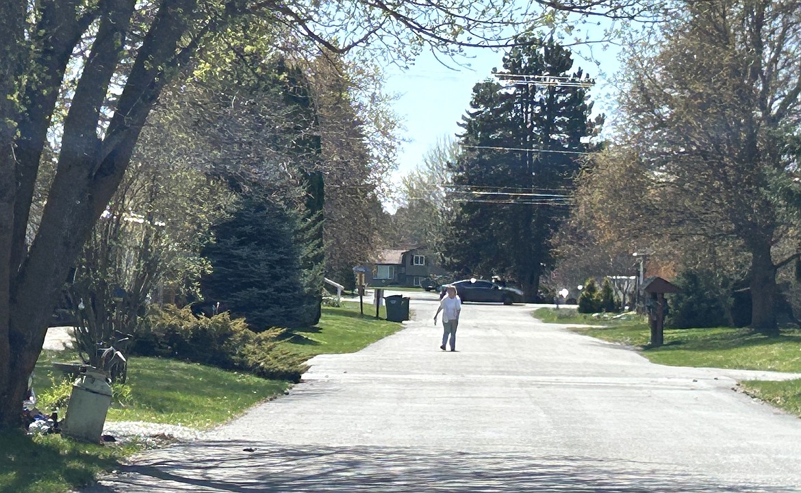 A resident walks down a street in Sun Aire Estates in Hayden.