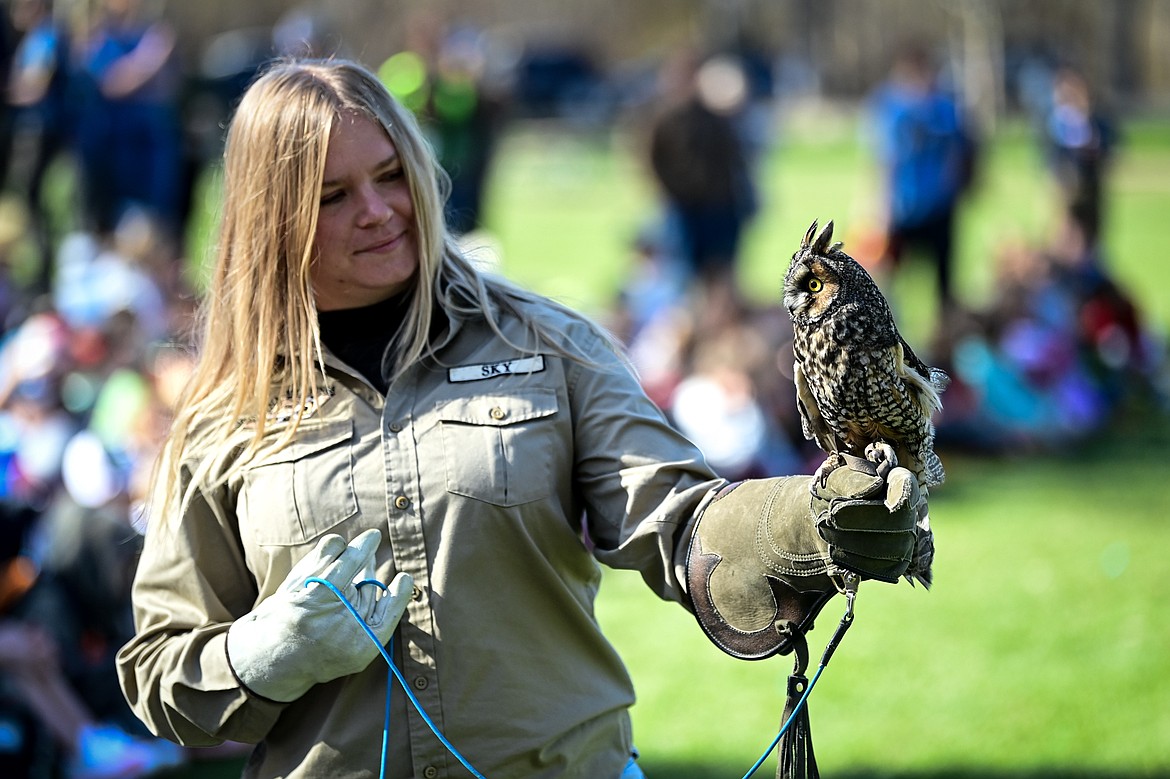 A volunteer with Montana Wild Wings Recovery Center holds a long-eared owl during a demonstration at the Arbor Day celebration at Lawrence Park on Friday, April 25. (Casey Kreider/Daily Inter Lake)
