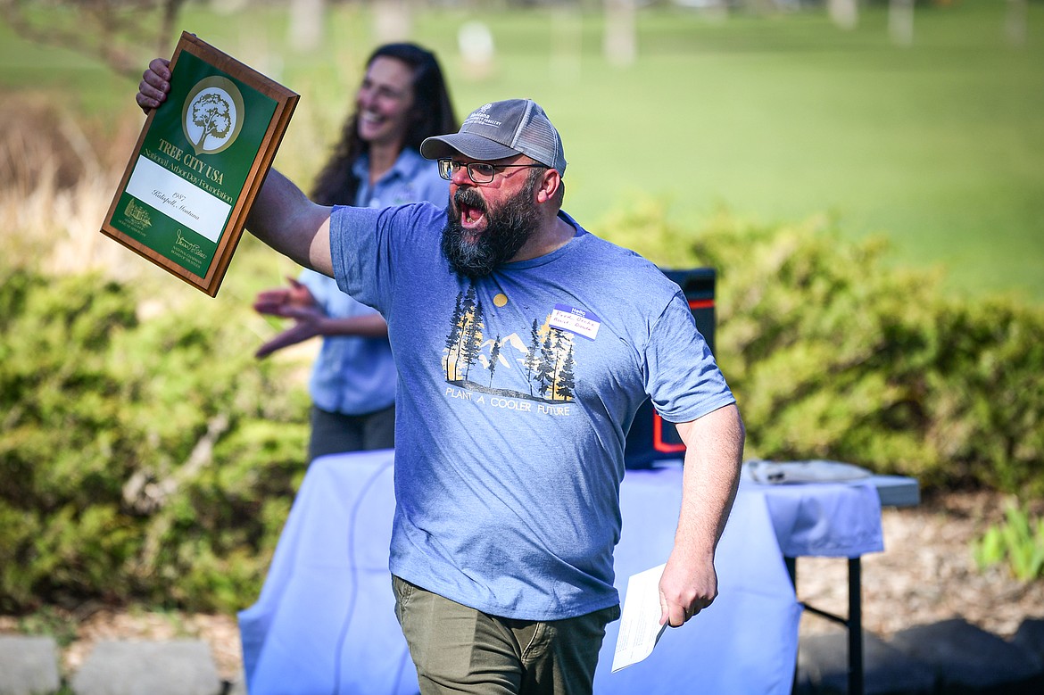 Fred Bicha, Parks Superintendent with Kalispell Parks & Recreation, receives the Tree City USA Growth Award on behalf of the city at the Arbor Day celebration at Lawrence Park on Friday, April 25. (Casey Kreider/Daily Inter Lake)