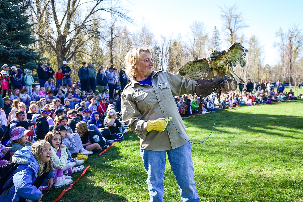 A volunteer with Montana Wild Wings Recovery Center holds a red-tailed hawk during a demonstration at the Arbor Day celebration at Lawrence Park on Friday, April 25. (Casey Kreider/Daily Inter Lake)