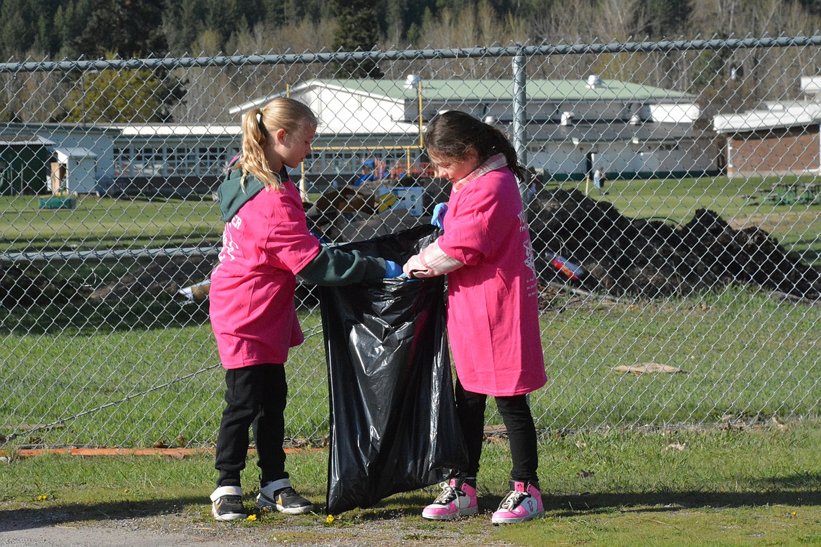 Friday, April 25, was Community Clean Up Day for the students at St. Regis School. Each spring, during the week of Earth Day, they spend part of a school day collecting trash around the school grounds, streets in town, and at the community park. The third-grade class made a trek around the school's fence line, grabbing litter and putting it in trash bags as they walked along. The youngest classes worked in the school yard, while the older grades picked up rubbish throughout neighborhoods, and raked at the park. (Mineral Independent/Amy Quinlivan)