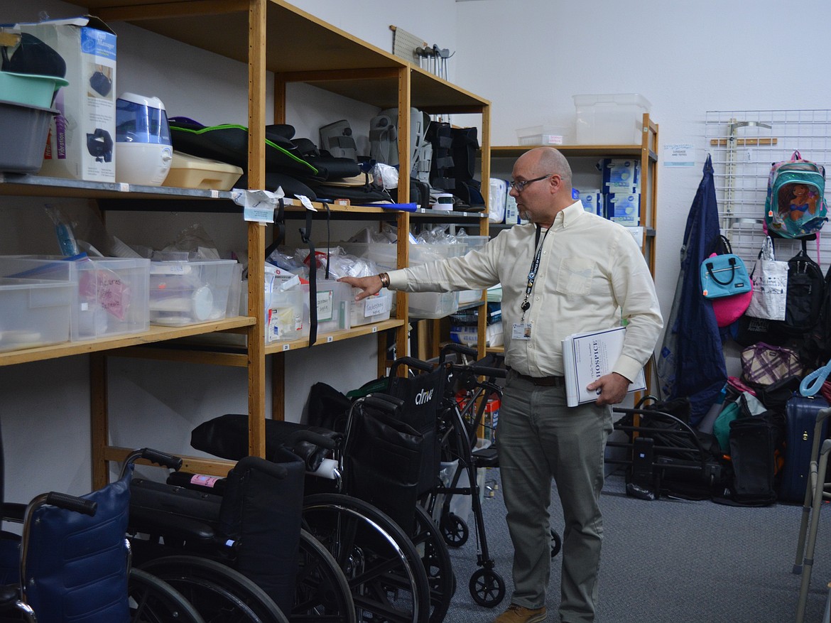 Some medical equipment such as wheelchairs or shower chairs is sold through the Hospice Thrift Store because of its connection to Hospice of North Idaho. Executive Director Eric Ladwig points out some of the different pieces for sale Monday at the store on Seltice Way.