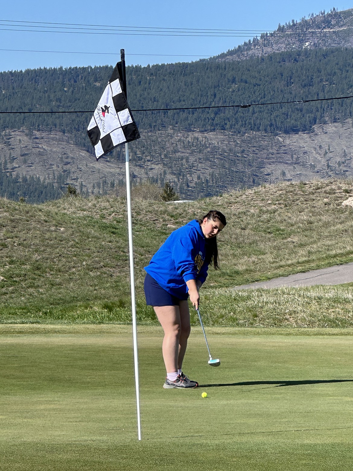 Thompson Falls' Olivia Nacarrini watches her putt approach the cup during this past week's Loyola Spring Swing golf tourney in Missoula.  (Photo by Doree Thilmony)