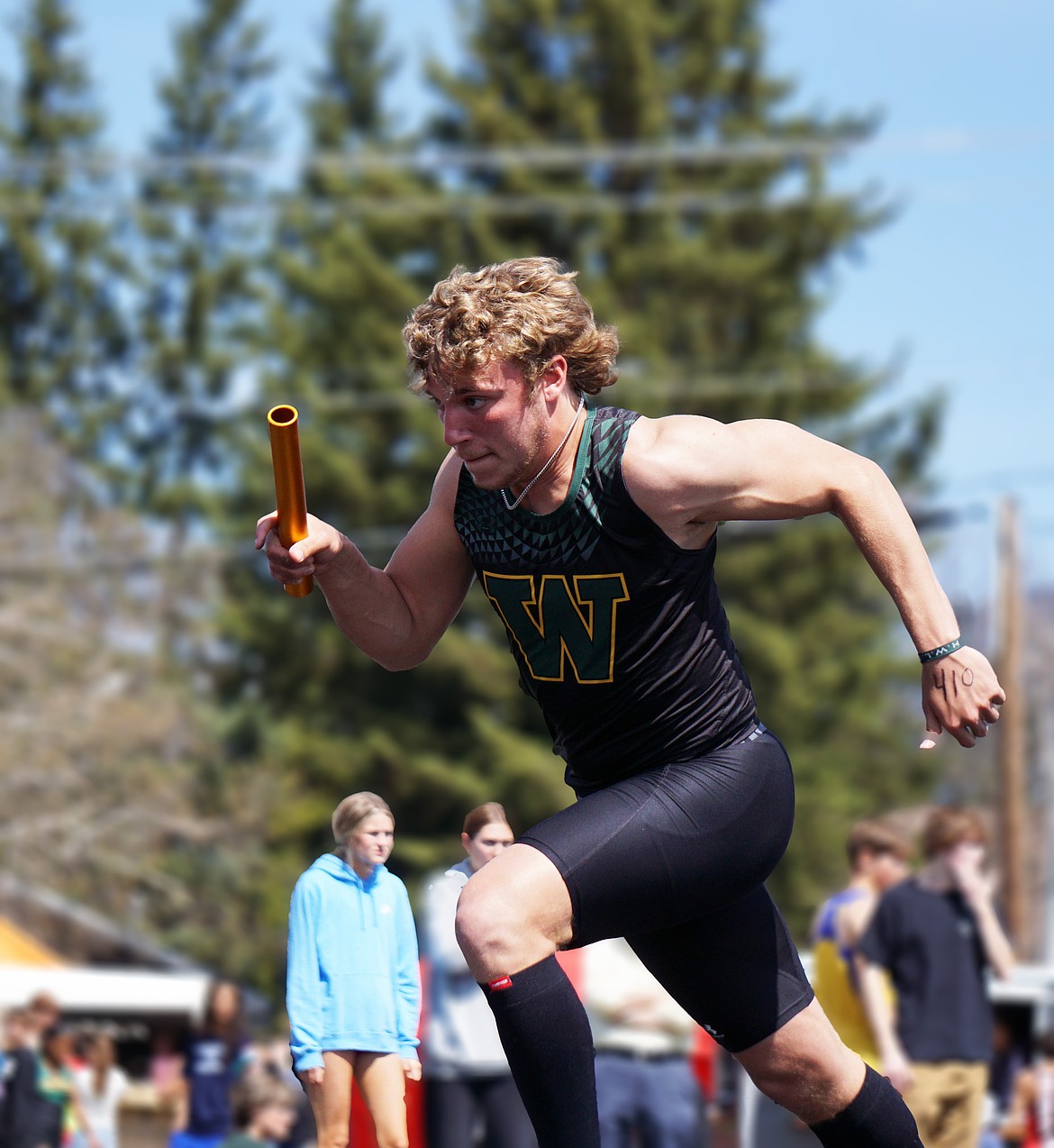 Bulldog Senior, Bodee Hanson, leads off the 4X100 relay in Whitefish Saturday afternoon. (Matt Weller photo)