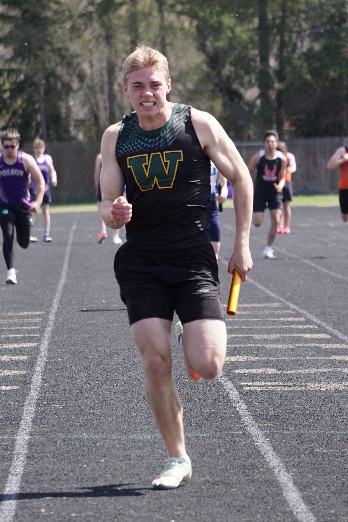 Preston McPherson (12) charges towards the finish of the men's 4x100 relay on Saturday. (Matt Weller photo)