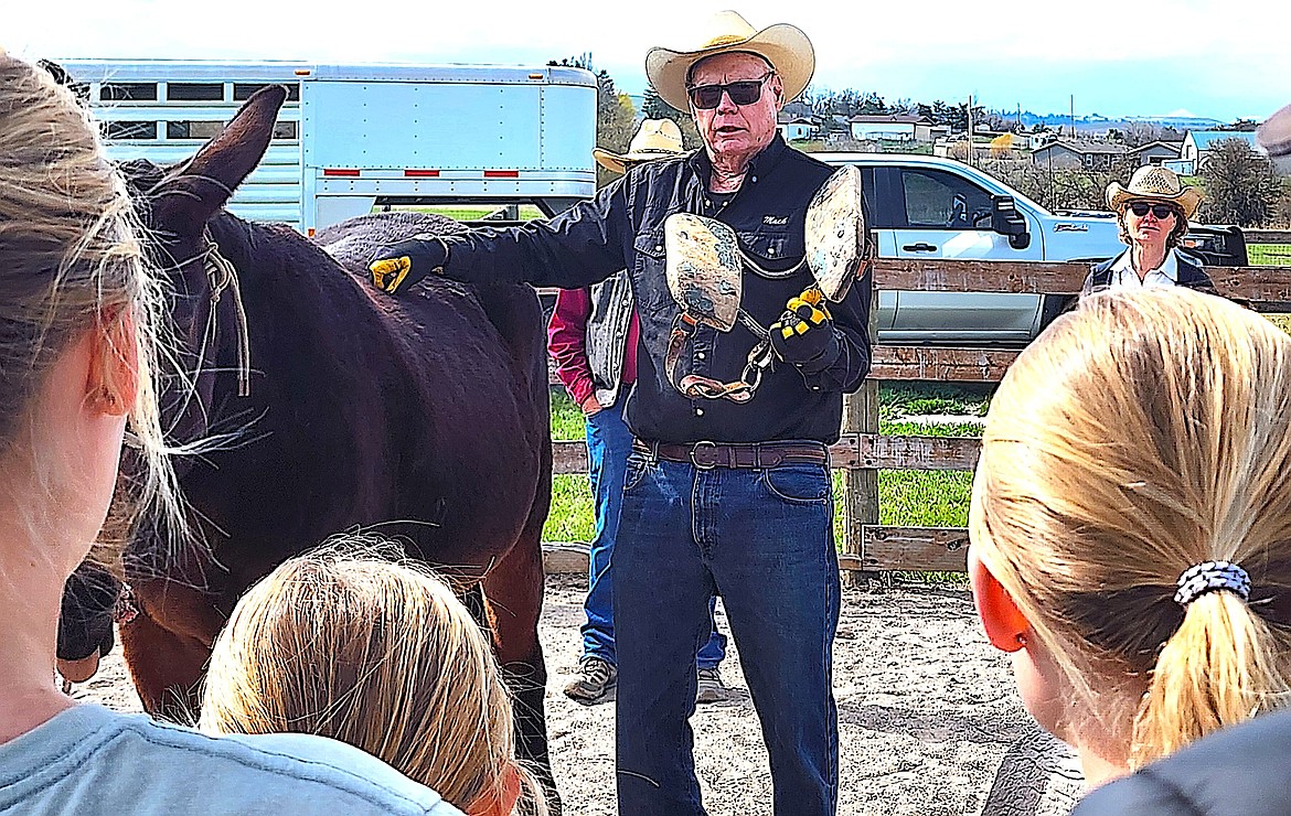 Mission Valley Back Country Horseman Mack Long holds up a Decker pack saddle so kids and parents can take a look. (Berl Tiskus/Leader)
