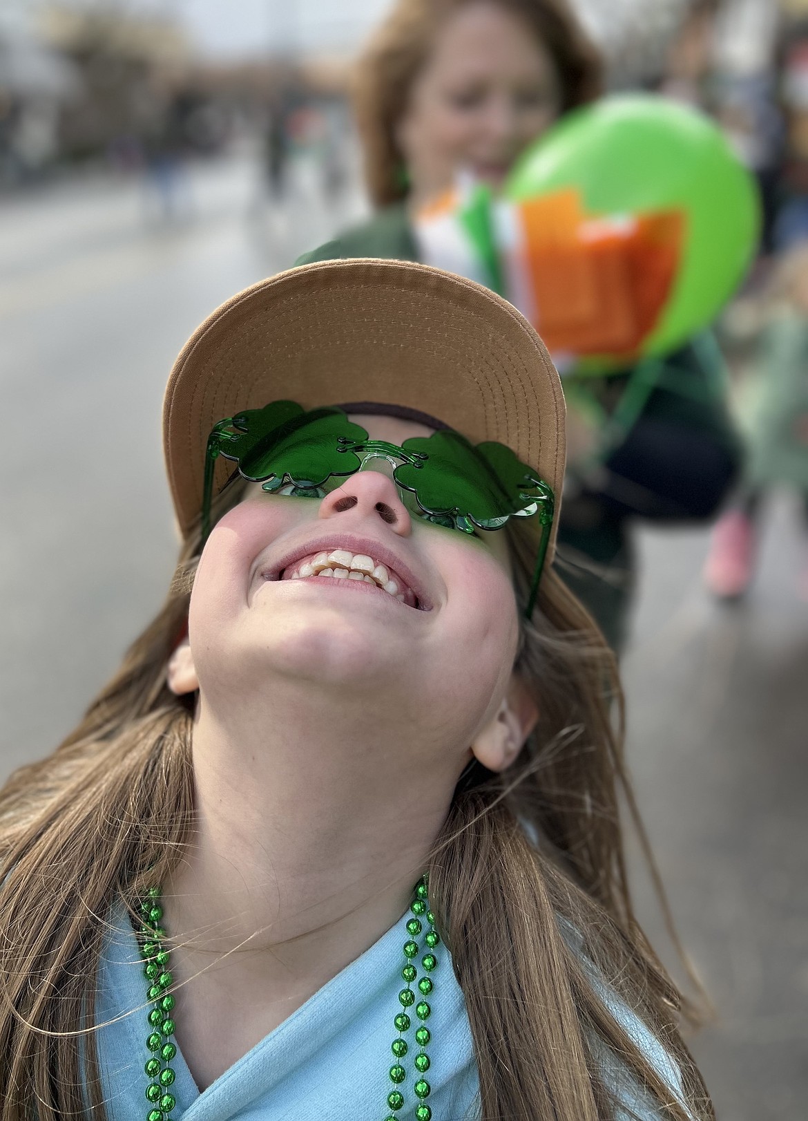 A girl laughs before the start of the St. Patrick's Day Parade in Coeur d'Alene.