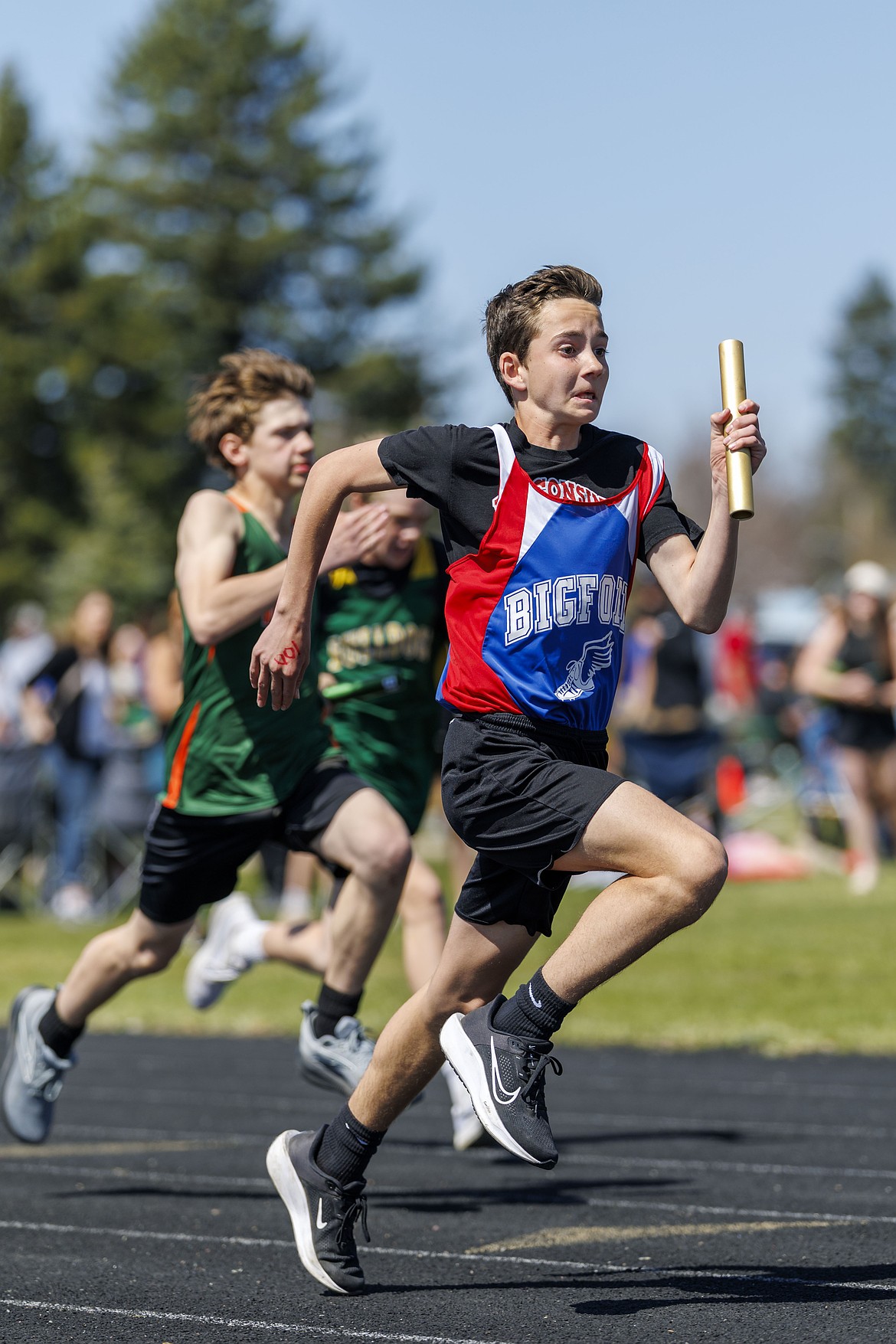 Bigfork middle school track team member Owen Alberio heads for his team mate with the baton at a meet in Whitefish.