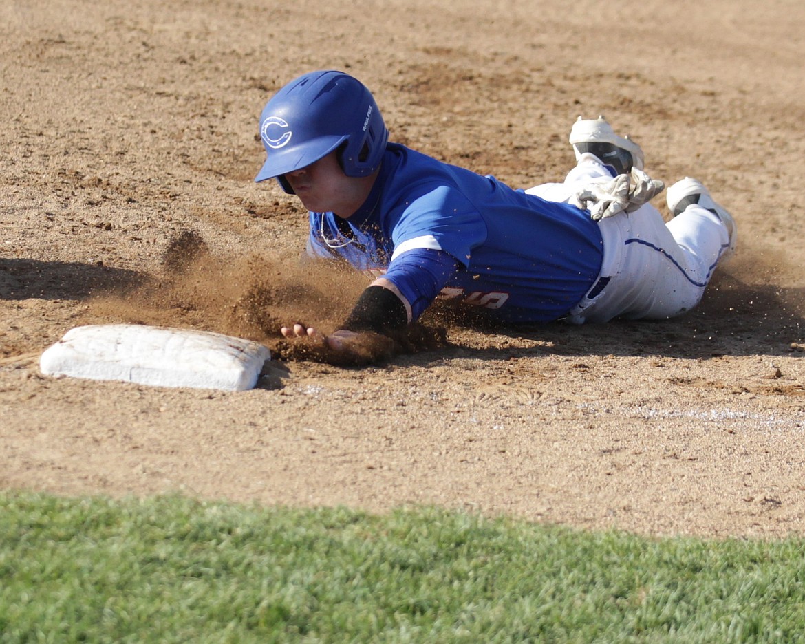 JASON ELLIOTT/Press
Coeur d'Alene junior Jackson Hackett dives back into first base to avoid a pickoff move during the fifth inning of Game 2 in the 6A District 1 baseball tournament at Lake City High on Thursday.
