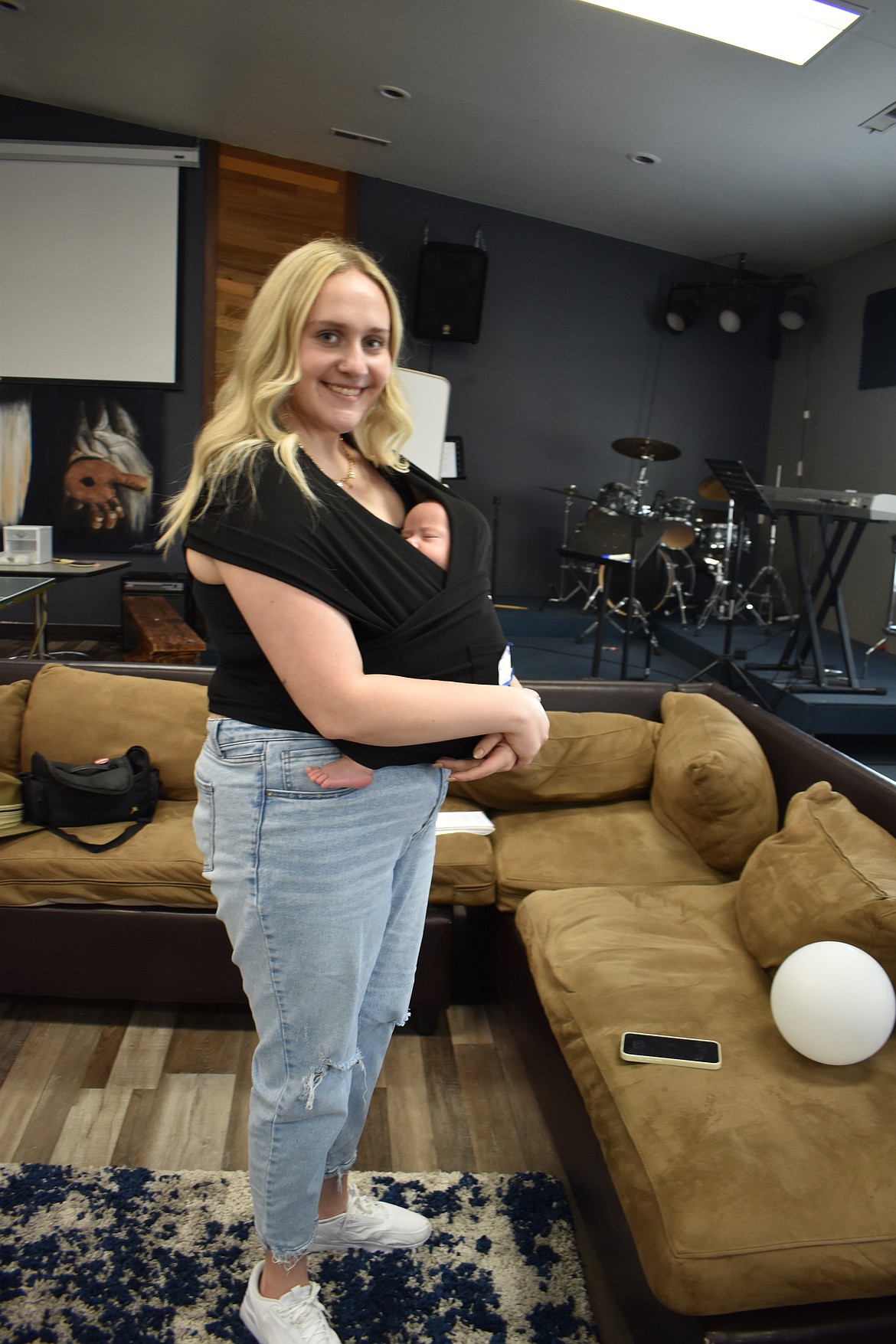 Taryn Janke, 19, snuggles her sleeping 3-month-old son Hudson at YoungLives Thursday. An unexpected pregnancy derailed some of Janke’s plans, but she’s found support both in her family and in YoungLives.