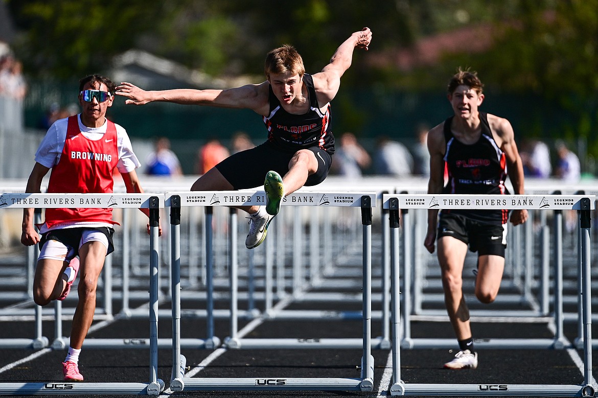 Plains hurdler Cody West powers over a hurdle during the Archie Roe Memorial track and field meet this past Saturday in Kalispell. (Casey Kreider/Daily Inter Lake)