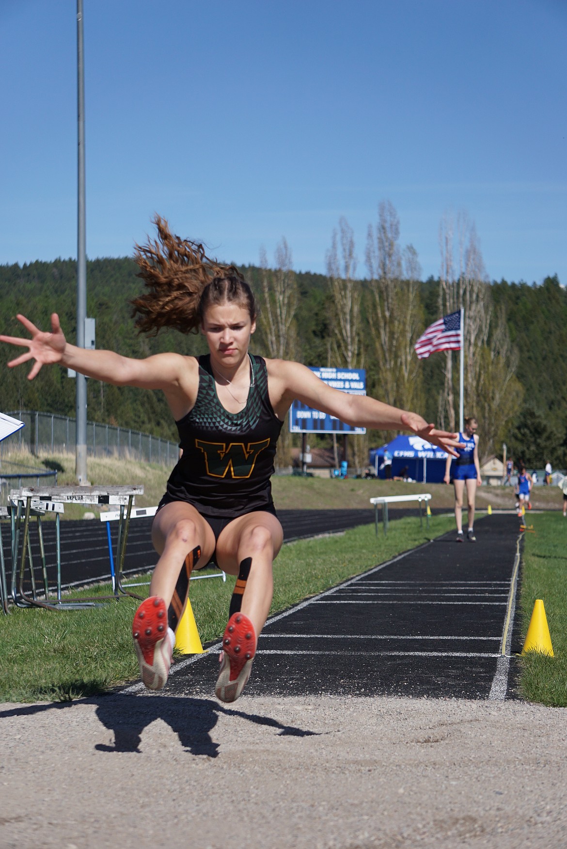 Whitefish freshman, Chantry Krack, takes the top step of the podium with a jump of 31' 1.75" in the women's varsity triple jump competition on Thursday. (Matt Weller photo)