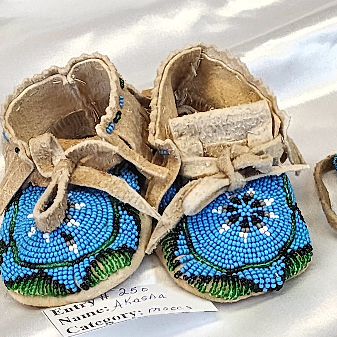 Akasha Amaya made and beaded baby moccasins for the Art Slam at Two Eagle River School. (Berl Tiskus/Leader)