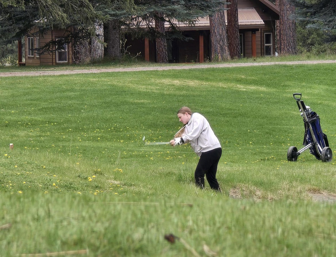 St. Regis junior Shelby Simkins hits out of the tall grass during the Trestle Creek St Regis Invitational this past weekend in St Regis. (Photo by Emily Park)