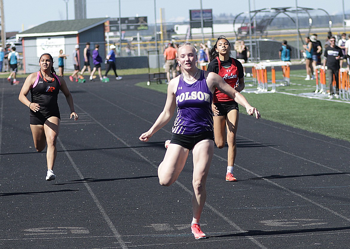 Polson's Amelia Stene starts off a dominate performance with a win in the 100m during the Lake County Track Meet. (Bob Gunderson photo)