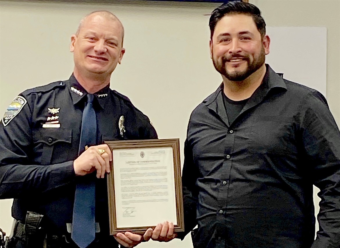 Polson Police Chief George Simpson presented Ryan Hunter with a Letter of Commendation for his heroic actions during a life-threatening incident last fall. (Courtesy photo)