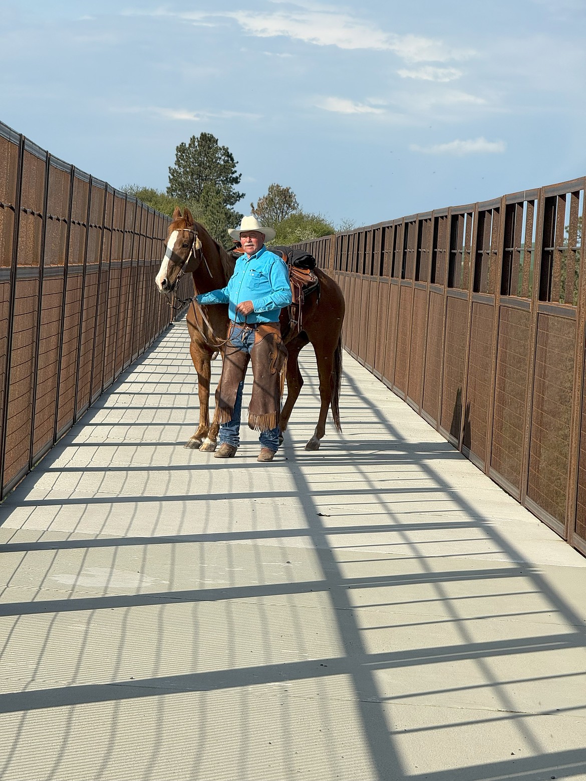 Ron Tebow stops on the 295-foot-long Tekoa Trestle that carries the Palouse to Cascades Trail over a large valley.