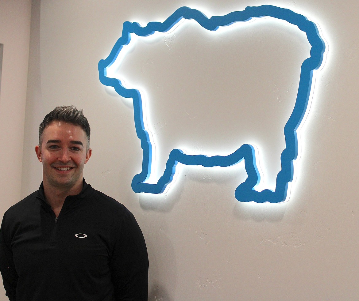 Dr. Gabe Dawson smiles behind the front desk for a photo. (Kaleb Unger/Leader)