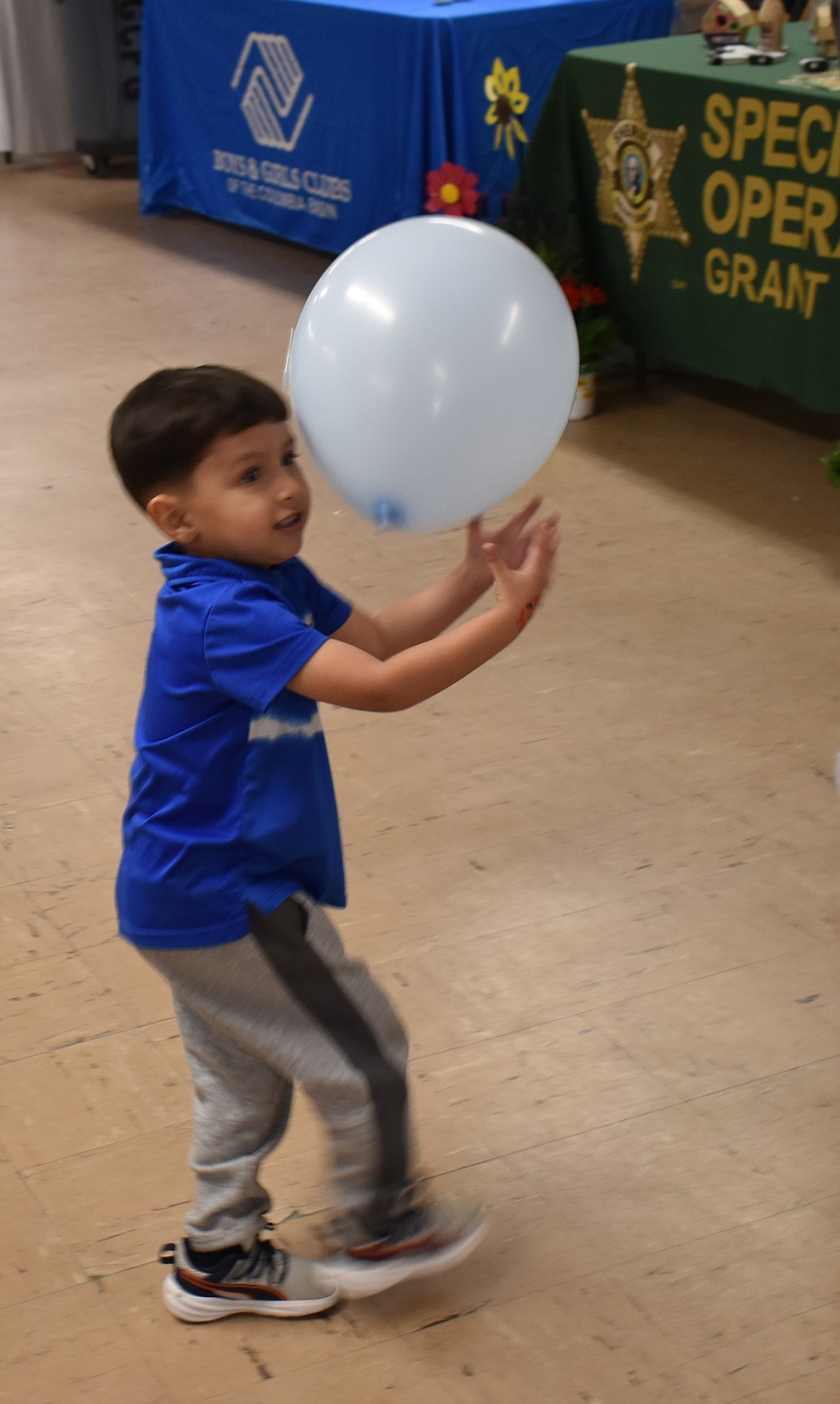 Three-year-old Dylan Aaron finds joy in a balloon at the Child Abuse Prevention Month event at the Grant County Fairgrounds April 9.