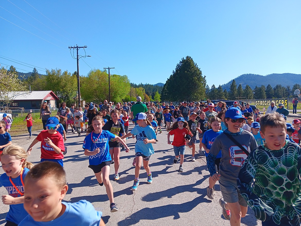 St. Regis School Principal Shawn Ball (green coat) gave the count down for the 1-Mile Run which had the younger students and more parents participating than the 5K on Thursday, May 8. (Monte Turner/Mineral Independent)
