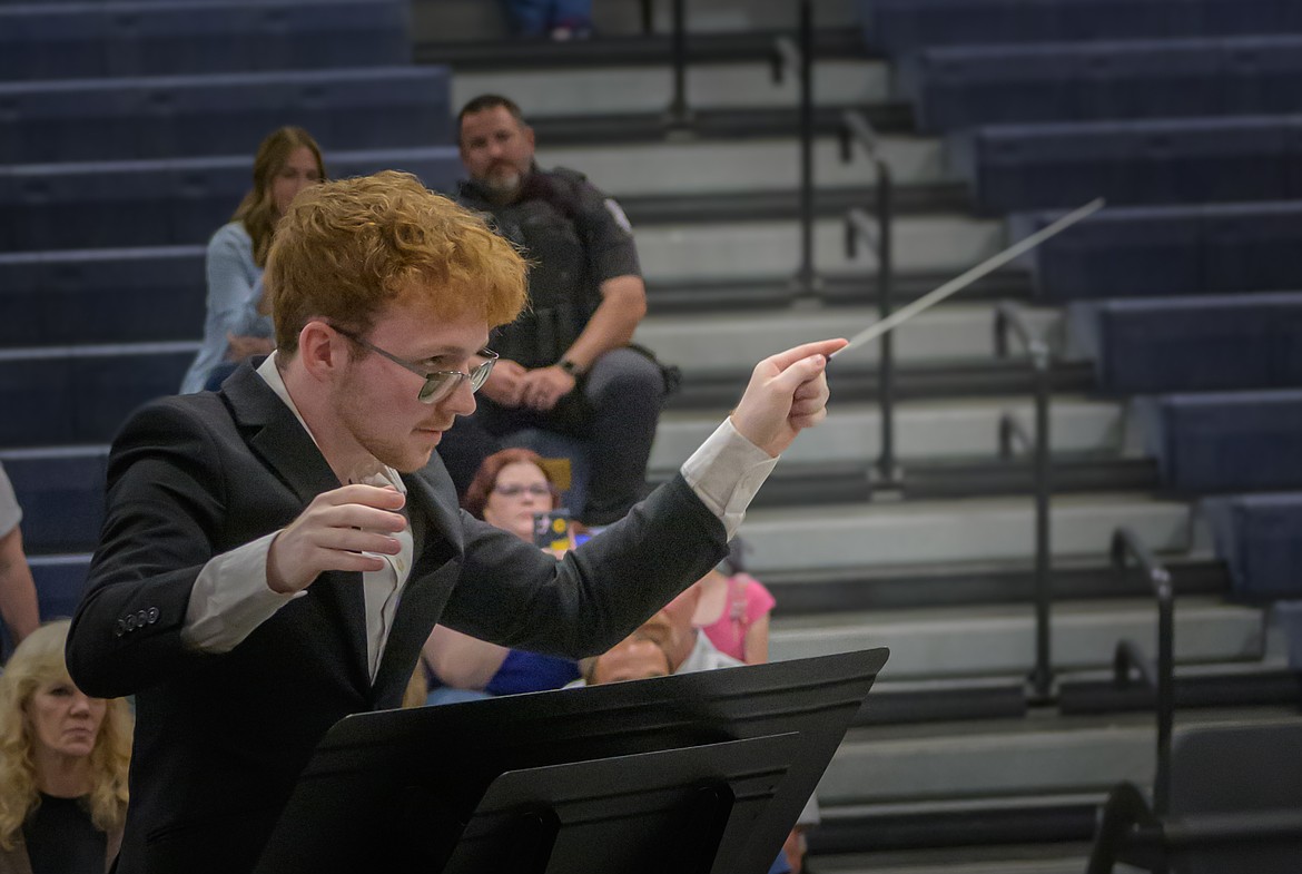 Senior Logan Steinebach conducts the Plains High School Band. (Tracy Scott/Valley Press)