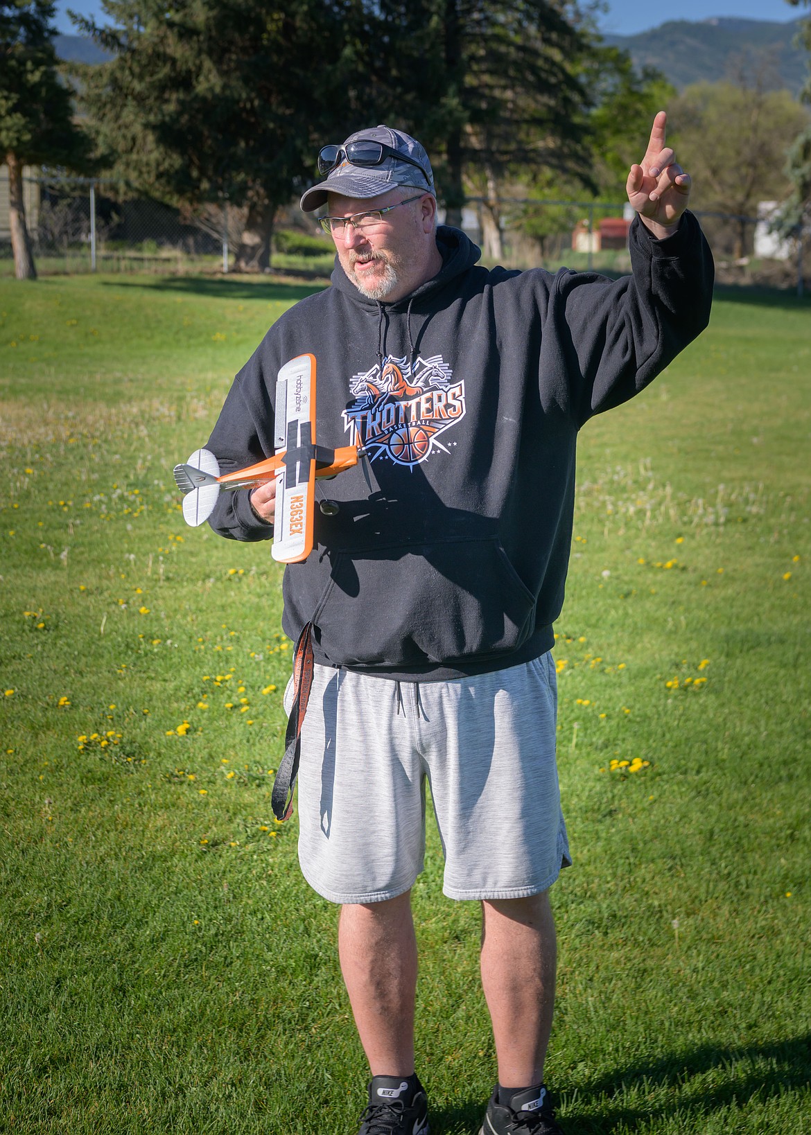 Plains teacher Brooks Sanford points in the direction where the RC planes go. (Tracy Scott/Valley Press)