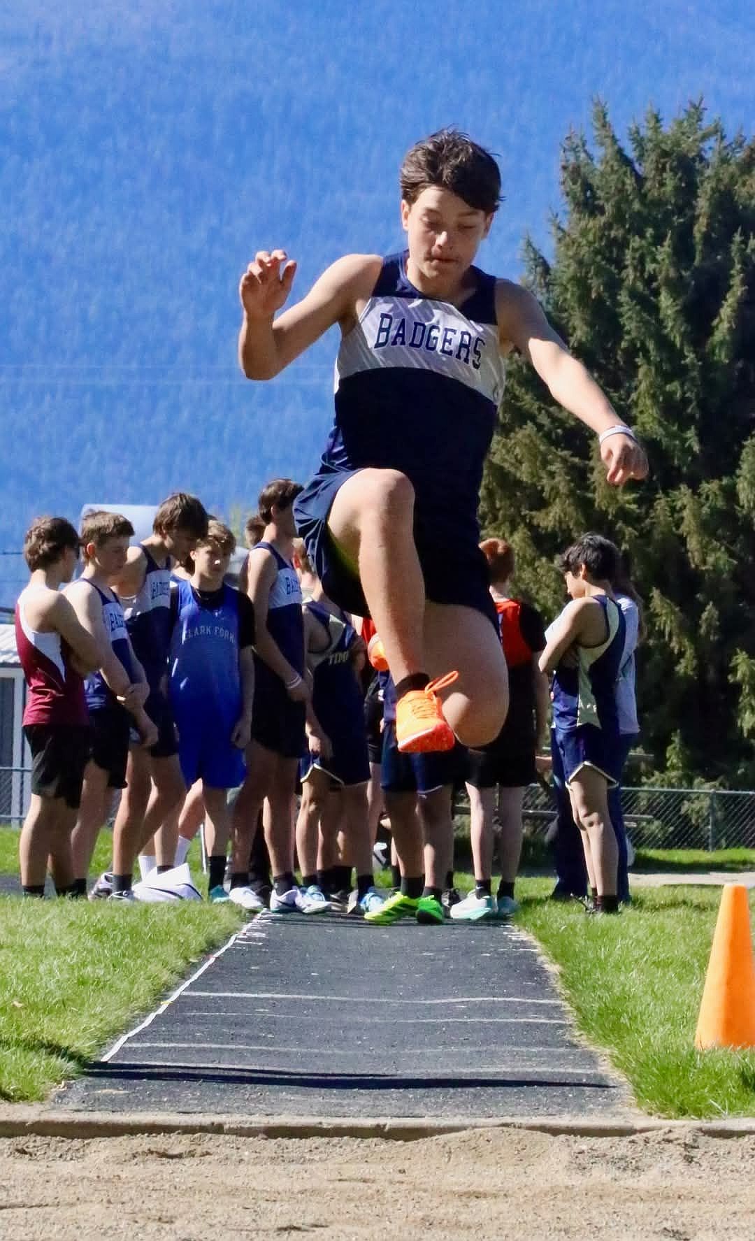 Boundary County seventh grader Cody Russell soars through the air while competing in the long jump at the middle school district championship meet.