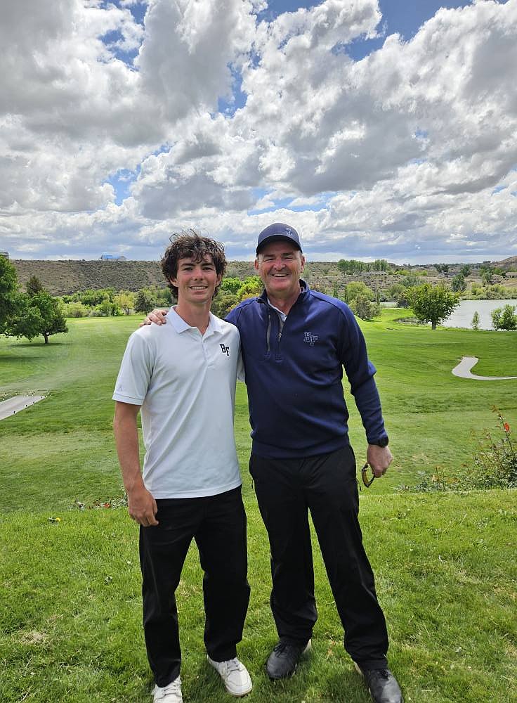 Left, Eli Blackmore, who received a sixth-place medal for his terrific finish at the 4A State Championship, stands next to Bonners Ferry High head coach Travis Blackmore.