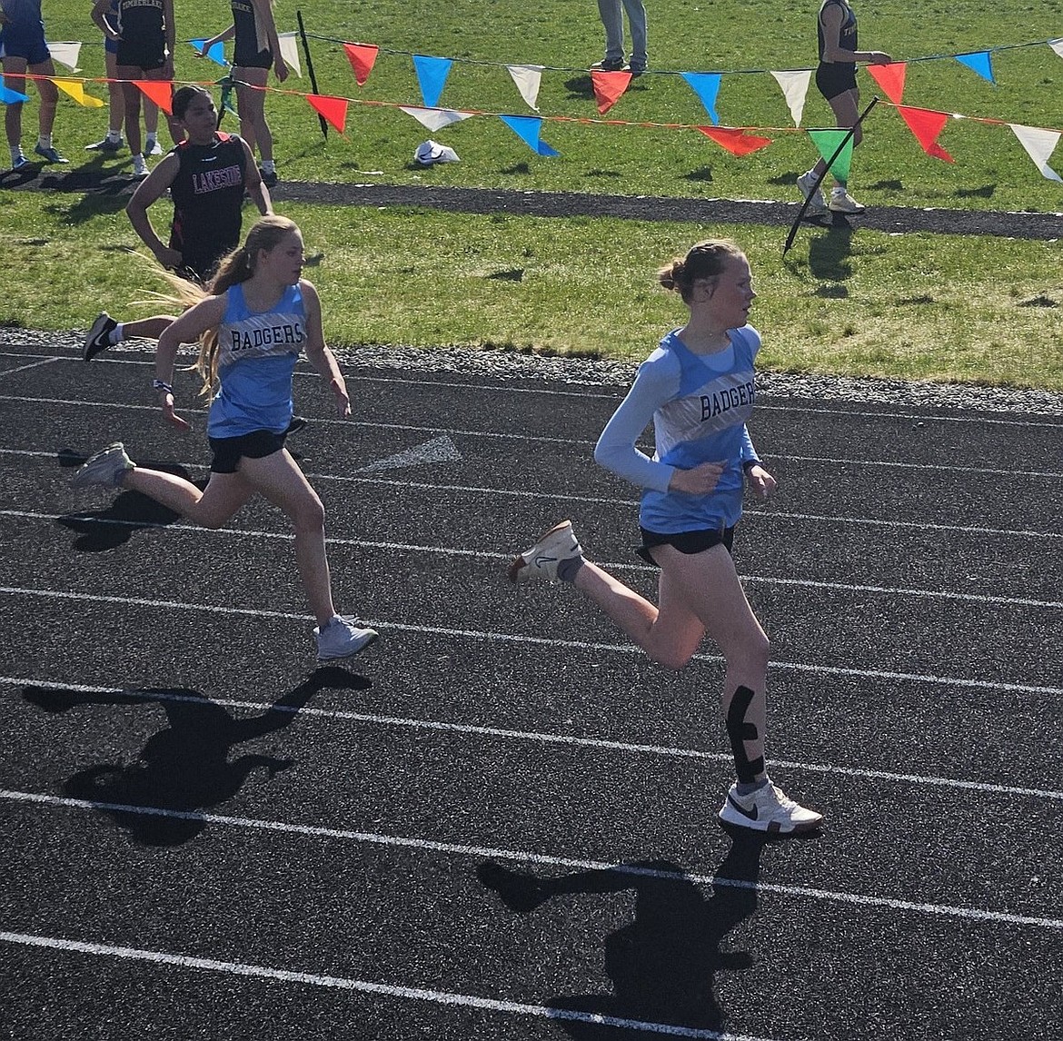 Boundary County eighth grader Paige Wyatt, right, competes in the 100-meter dash at the middle school district championship meet.