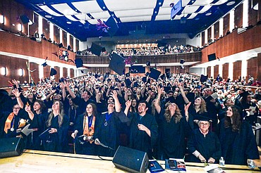 Graduates toss their mortarboards into the air during Flathead Valley Community College's Class of 2025 Commencement at the Wachholz College Center on Friday, May 16. (Casey Kreider/Daily Inter Lake)