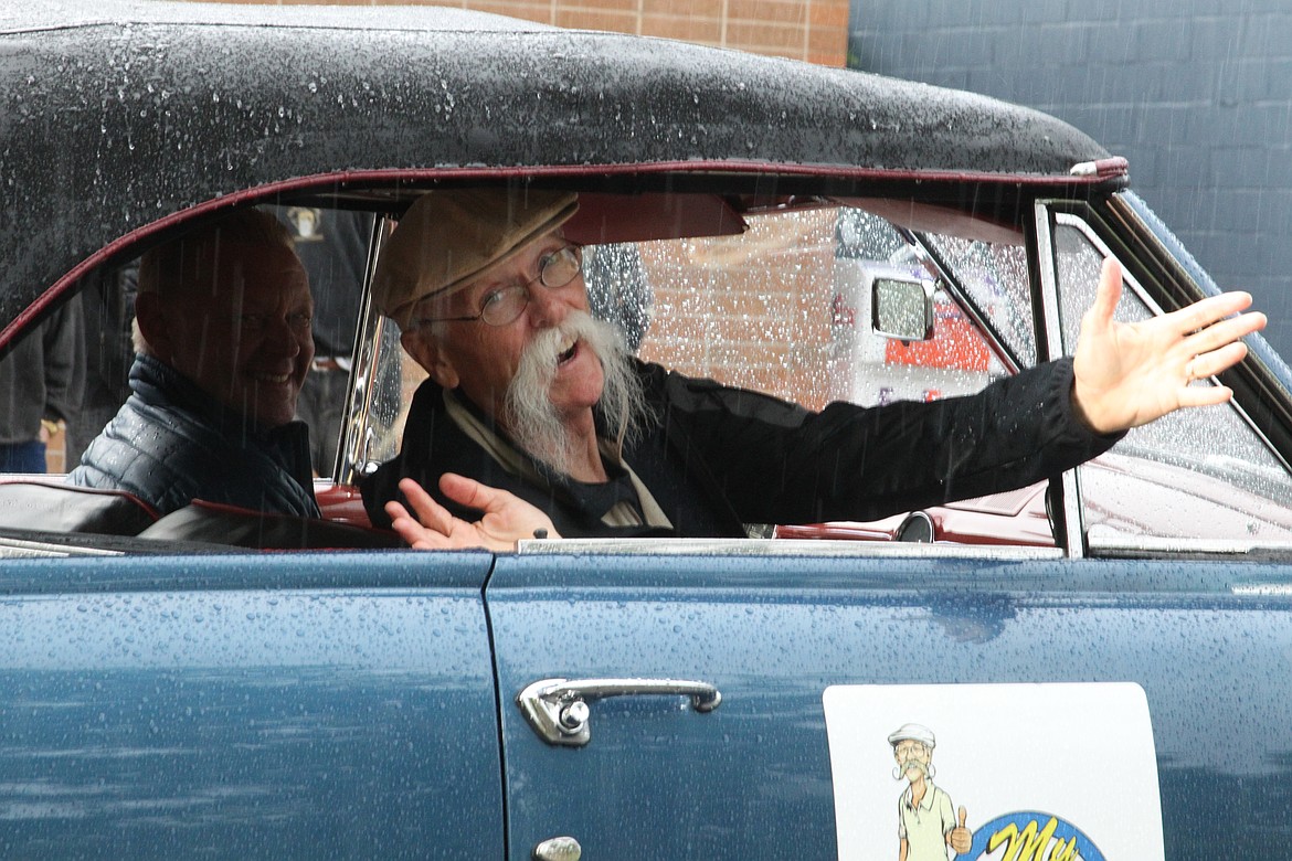 Dennis Gage, host of "My Classic Car" says hello during the in the '50s classic car cruise on Friday.