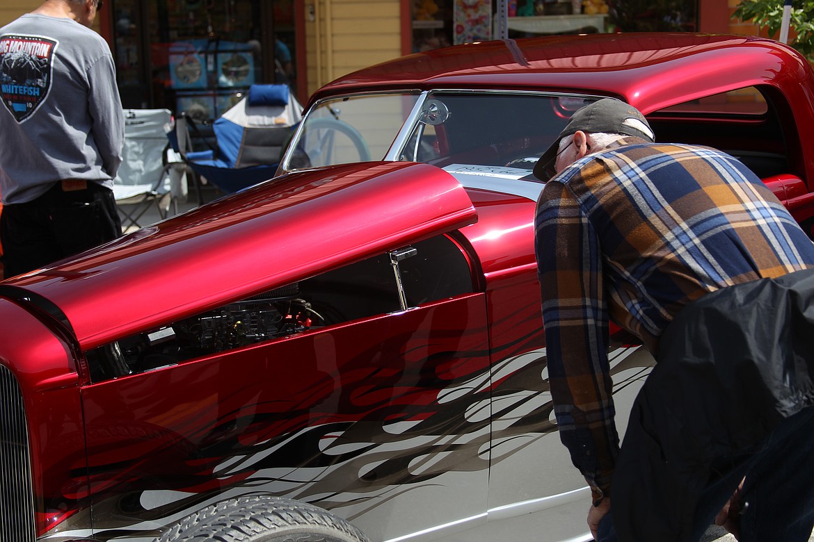 Lonnie Best checks out a classic car at Saturday's Lost in the '50s car show.