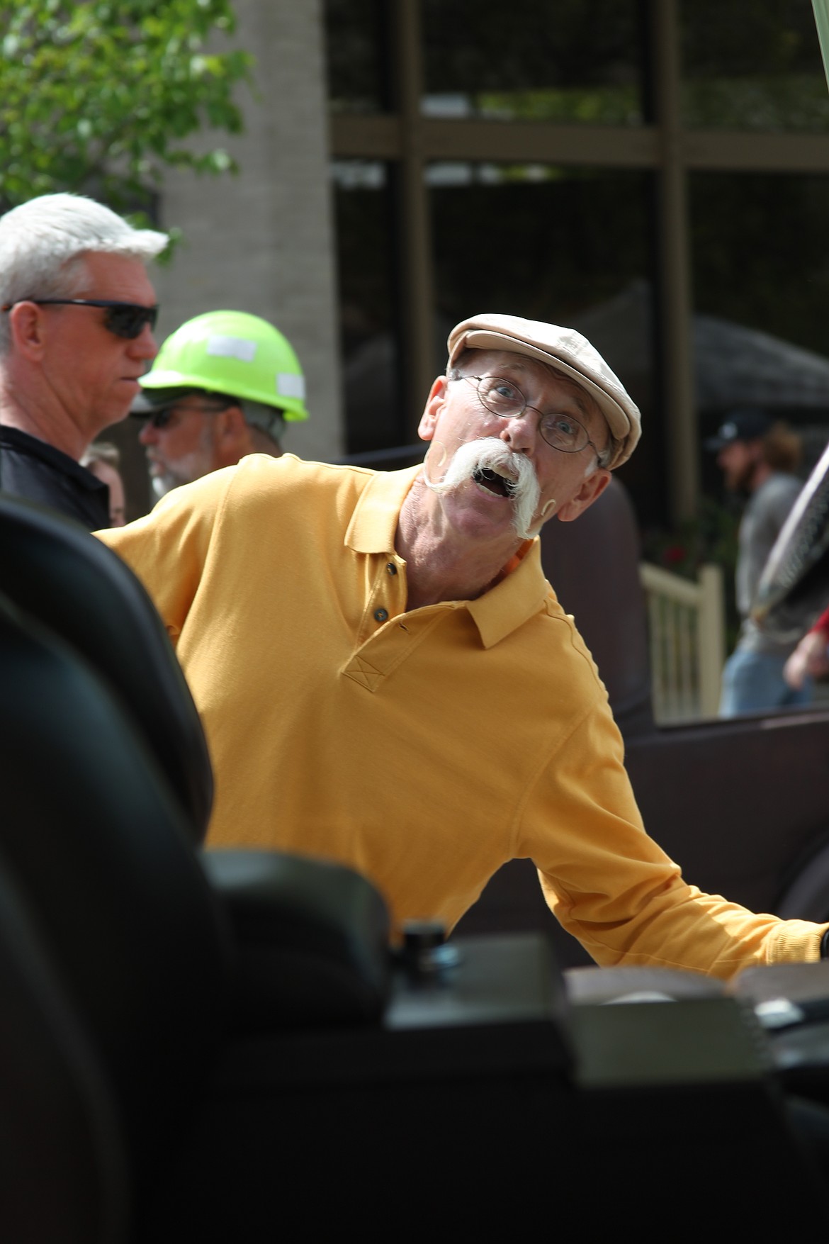 Dennis Gage of "My Classic Car" smiles through the open door of a classic car at Saturday's Lost in the '50s car show.