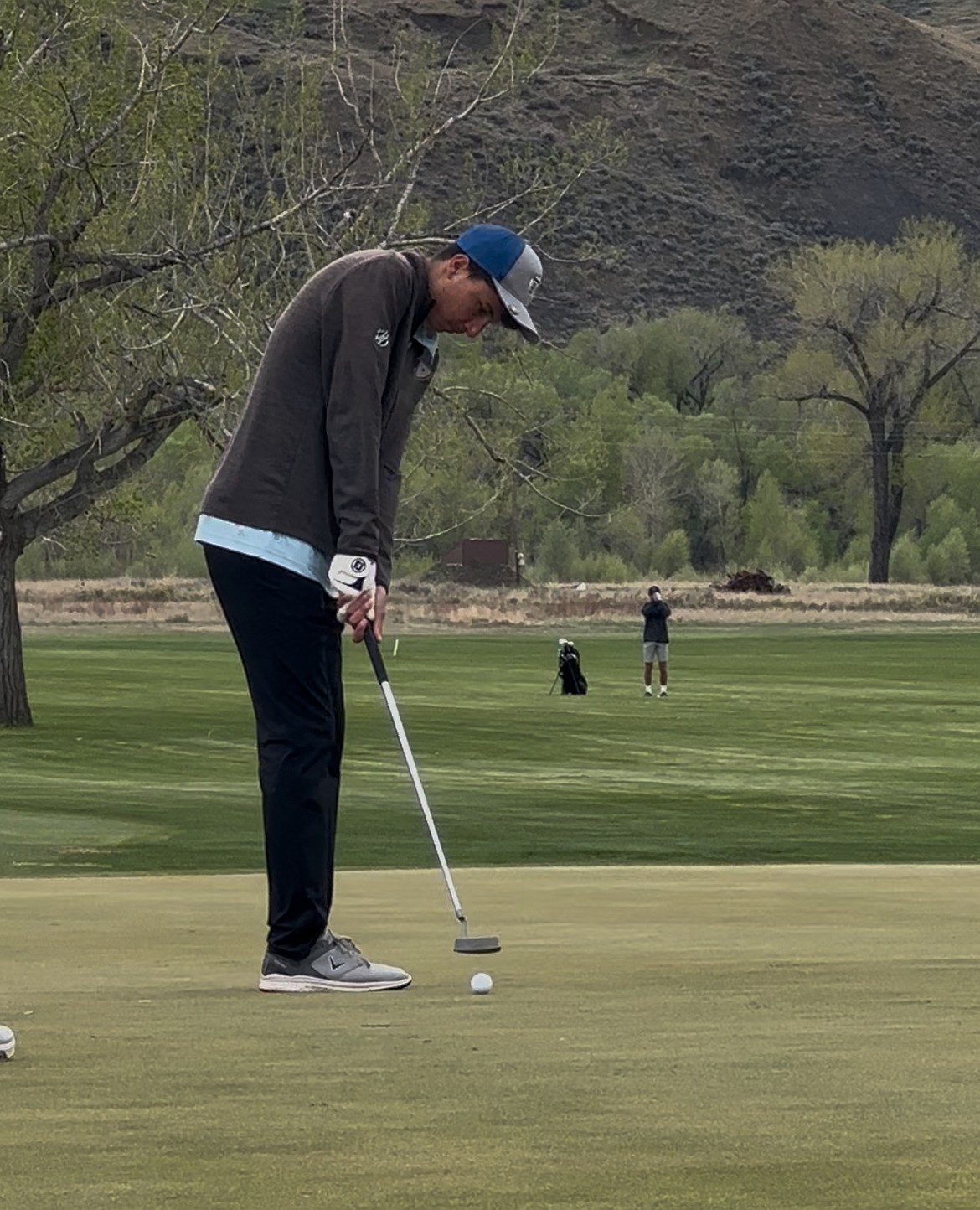 Thompson Falls senior Blake Shusterman watches a put head toward the cup during this past week's Class B state golf championships in Shelby. (Photo by Doree Thilmony)